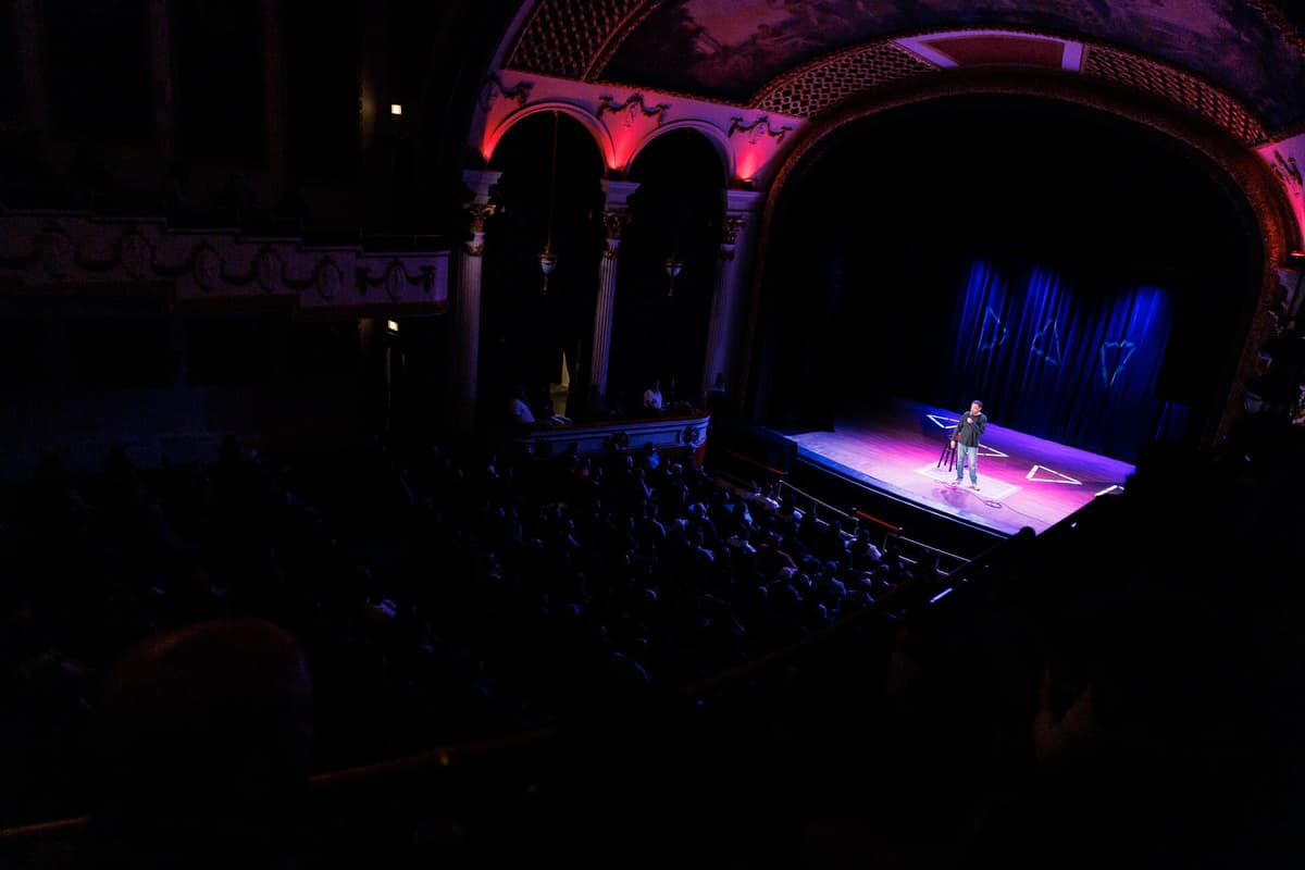 Comedian in the spotlight on stage from the balcony