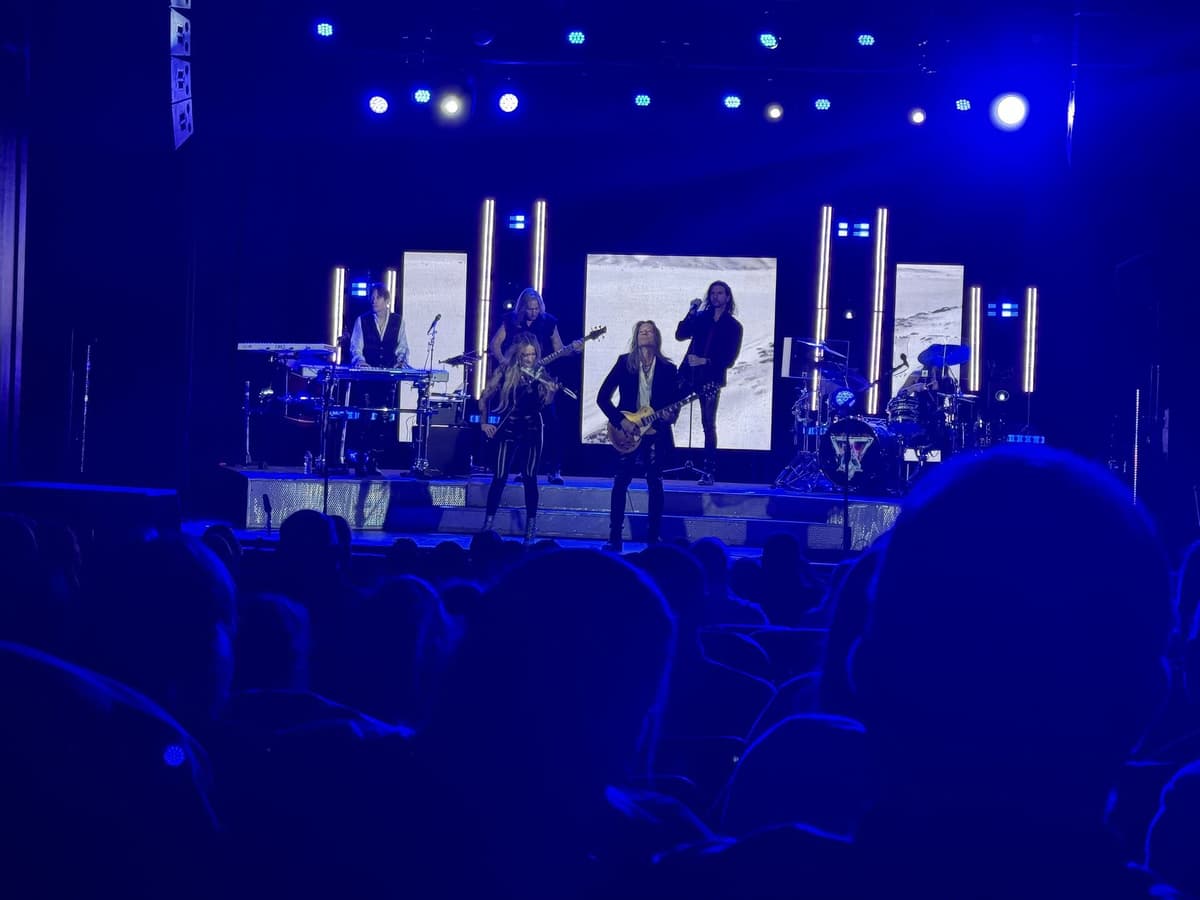 Band performing under blue stage lighting