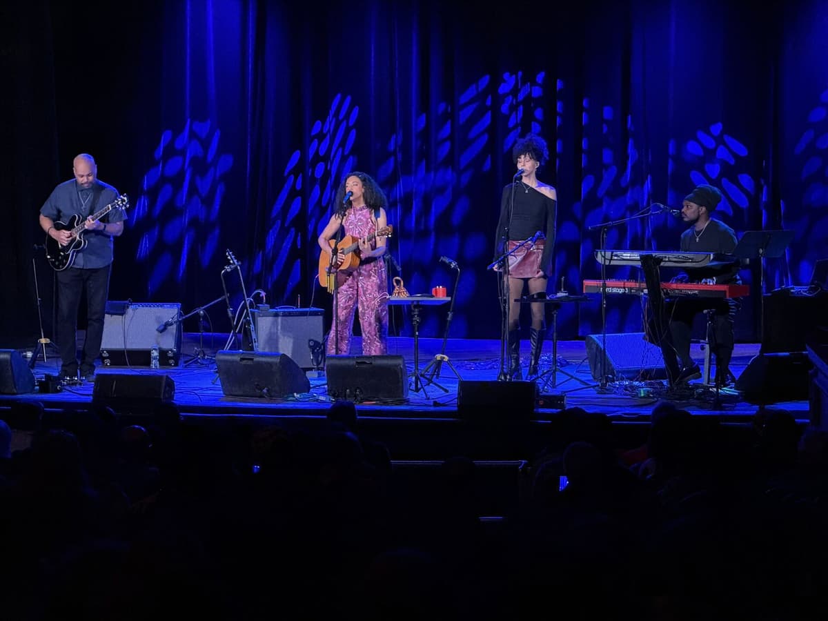 Musicians performing with dappled blue backdrop